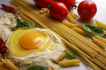 Composition with fresh ingredients for pasta on light table