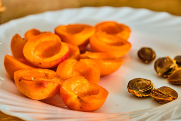 Apricots on white plate