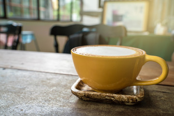 Hot latte art coffee on wood table