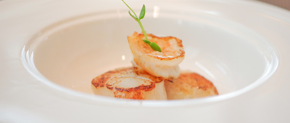 Grilled shrimp seared scallops in white bowl plate