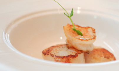 Grilled scallops seared shrimp in white bowl plate