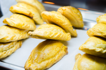 Typical breakfast in Latin American countries, Fried empanadas on wood background
