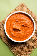 Peri Peri Sauce in a bowl, originally from portugal, it's a hot sauce made using piri piri or African bird's eye chillies.  selective focus