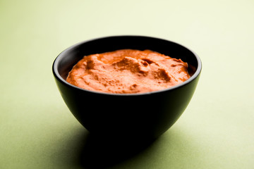 Peri Peri Sauce in a bowl, originally from portugal, it's a hot sauce made using piri piri or African bird's eye chillies.  selective focus