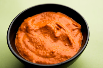 Peri Peri Sauce in a bowl, originally from portugal, it's a hot sauce made using piri piri or African bird's eye chillies.  selective focus