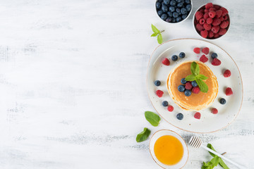 American pancakes with fresh berries and honey