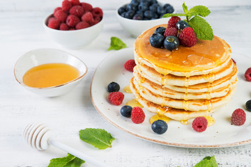 American pancakes with fresh berries and honey
