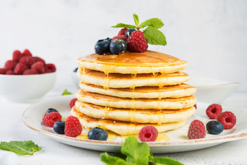 American pancakes with fresh berries and honey