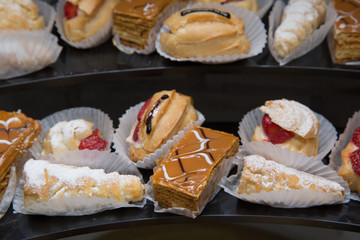 A lot of french dessert of profiteroles eclair choux pastry. Ekler Pasta Chocolate Donut in plate.