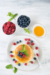 American pancakes with fresh berries and honey