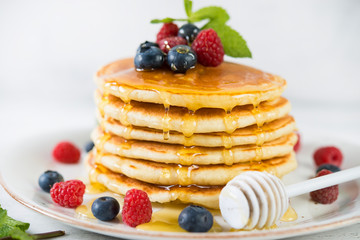 American pancakes with fresh berries and honey