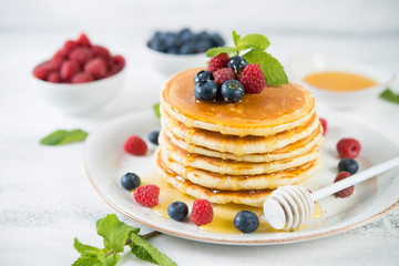 American pancakes with fresh berries and honey