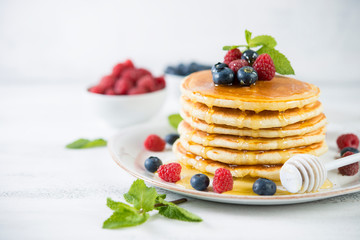 American pancakes with fresh berries and honey