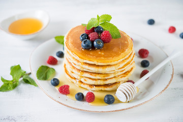 American pancakes with fresh berries and honey