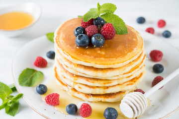 American pancakes with fresh berries and honey