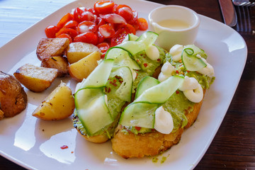 Close up shot of plate of grilled bread with Avocados sauce on top