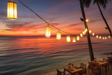 Outdoor cafe on the beach during sunset on Koh Chang island, Thailand.
