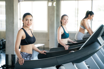 Fototapeta na wymiar Group of sport asian women running on treadmill