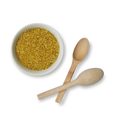 bowl of bulgur grains on a white background, top view