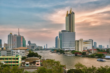 Bangkok skyline and business skyscrapers at Chaopraya river at sunset
