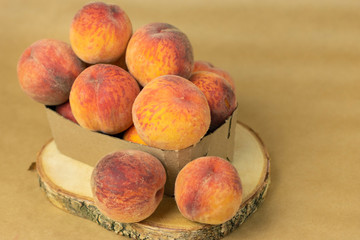 Ripe peaches in a plate on a wooden background. Close-up peaches Healthy food concept, plant background, natural eco-products, organic food, vegetarian, vegetables, raw, festival food