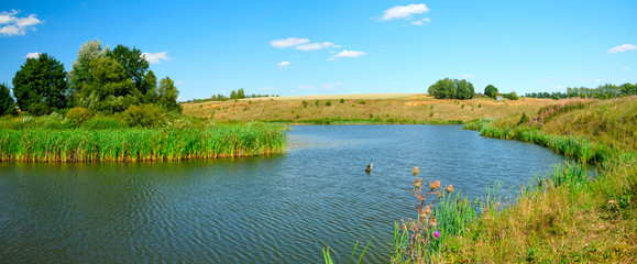 Obraz na płótnie Canvas landscape with lake and blue sky