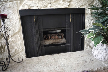 Retro fireplace with screen and painted rock
