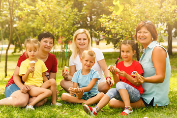 Fototapeta premium Happy mothers and children in the park