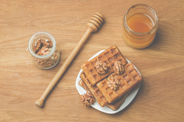 Wafers. Home made pastries, wafers and walnut with honey on a wooden table. Top view