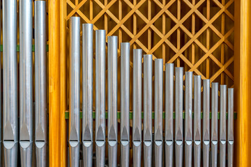 High-quality silver organ pipes in golden frame, background, symbol picture