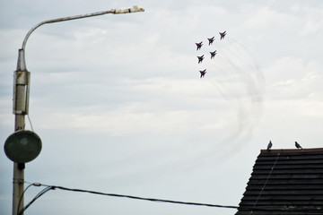A group of 6 Russian fighter Fulcrum-A (MiG 29) in flight over the city