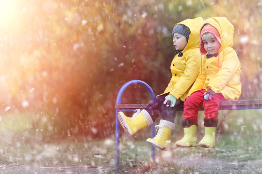 A Child In A Raincoat For A Walk Outside In Autumn