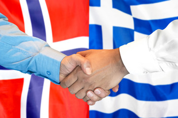 Business handshake on the background of two flags. Men handshake on the background of the Norway and Greece flag. Support concept