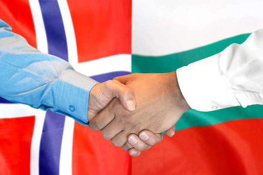 Business handshake on the background of two flags. Men handshake on the background of the Norway and Bulgaria flag. Support concept