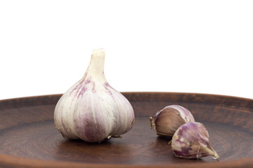 garlic on clay plate isolate