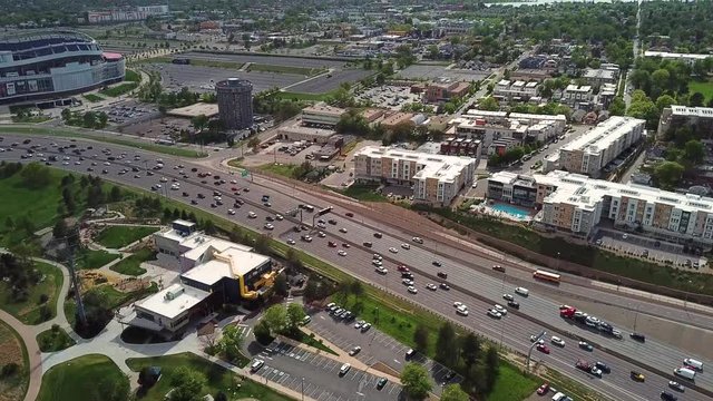 Cinematic Aerial Overview of Highway Evening Traffic on Denver Colorado Northwest With Mile High Football Stadium in Background