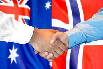 Business handshake on the background of two flags. Men handshake on the background of the Norway and Australia flag. Support concept