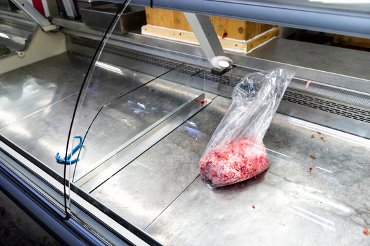 One Plastic Bag With Mince, Minced, Ground Beef Lying In Empty Refrigerated, Fridge Retail Display In Store, Butcher Shop