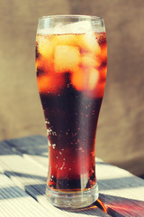 A glass covered with dew drops with a cold drink.