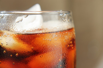 A glass covered with dew drops with a cold drink.