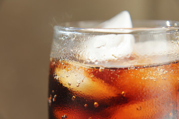 A glass covered with dew drops with a cold drink.