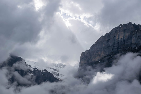 Hight Alps mountains and white clody sky with sunlight