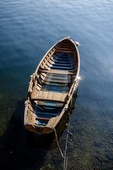 lonely boat anchored, view of a lonely and empty boat anchored at sunset. loneliness and freedom