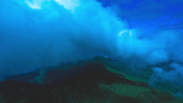 The flight above the mountain on a blue cloud stream background. Hyperlapse