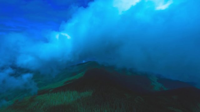 The flight above the mountain against the blue cloud stream. Hyperlapse