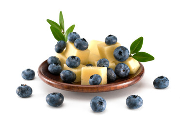 blueberries with cheese in a plate on a white background