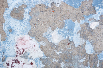 Background concrete wall with peeling blue and white paint. Horizontal photo format
