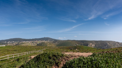 Fototapeta na wymiar Panoramic view of mountains, meadow, grass, blue sky and clouds on a sunny day, Portugal