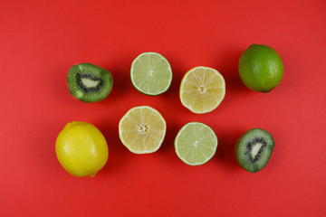citrus and kiwi on a red background upside