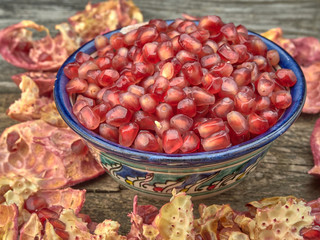 Delicious juicy red pomegranate.On wooden background